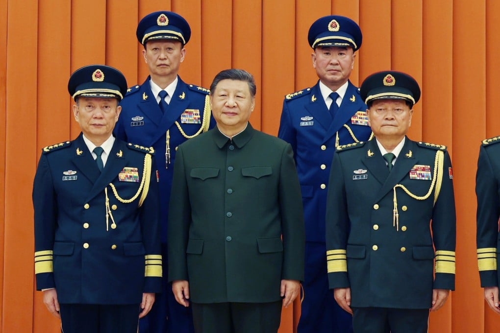 President Xi Jinping (centre), also chairman of the CMC, poses with top military officers at the promotions ceremony in Beijing on Monday. Pictured at the back are newly promoted generals Yang Zhibin (left) and Han Shengyan. Photo: AP