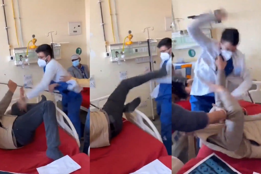 Screenshot from a video filmed by an attendant at Indira Gandhi Medical College and Hospital on Monday showing a masked doctor punching a man lying on a bed. Photo: X