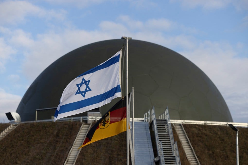 Flags flutter in front of the Arrow 3 air defence system in Annaburg, Germany. Photo: Reuters