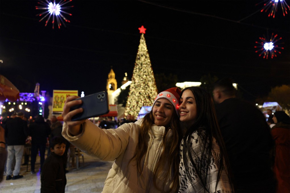 People celebrate in Manger Square in Bethlehem, in the Israeli-occupied West Bank on December 24. Photo: AFP