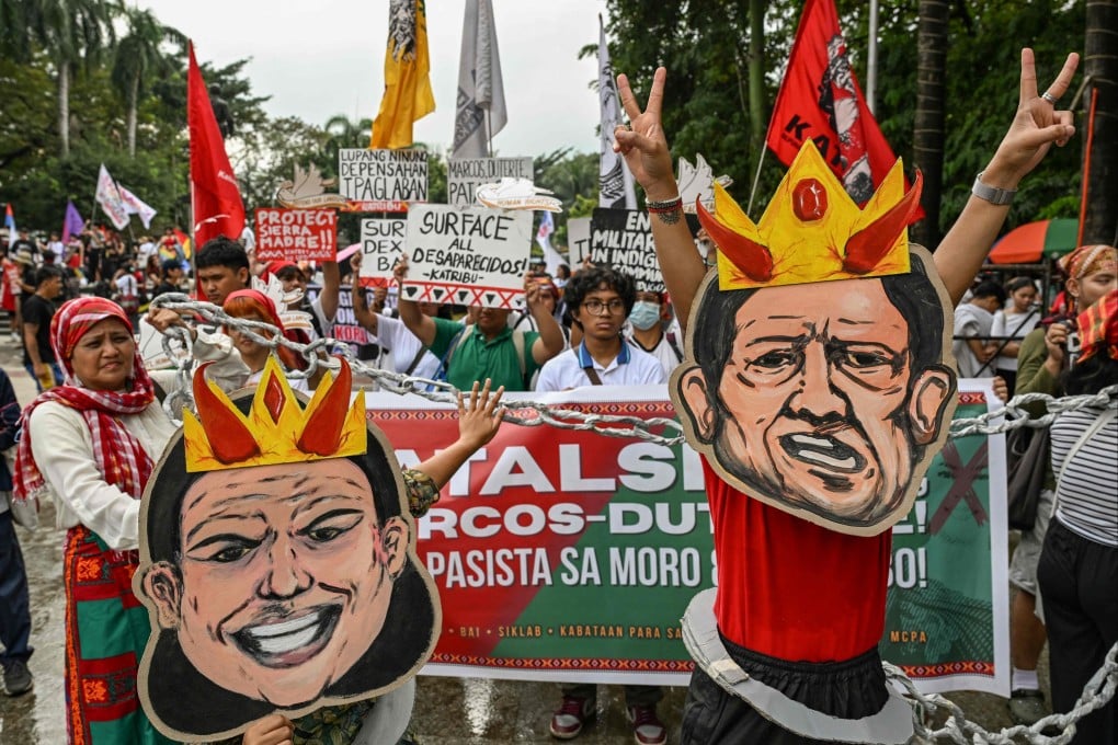 Protesters wearing masks depicting the faces of Philippine Vice-President Sara Duterte and President Ferdinand Marcos Jnr march during a rally to mark the International Human Rights Day in Manila on December 10. Photo: AFP