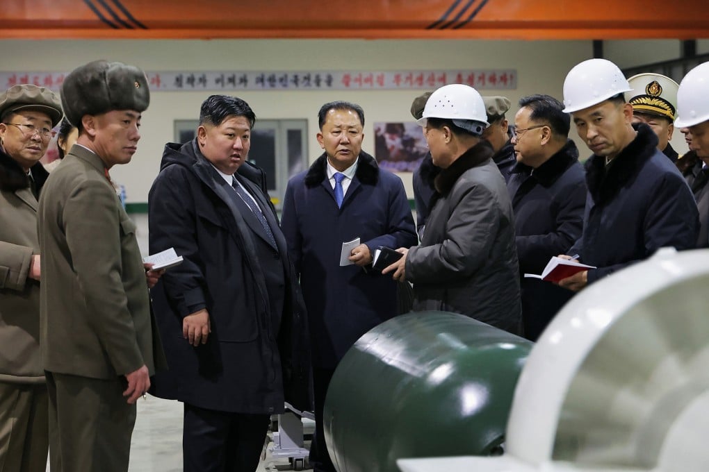 North Korean leader Kim Jong-un (centre)  inspects a nuclear-powered submarine under construction in a photo released on December 25. Photo: KCNA/AP