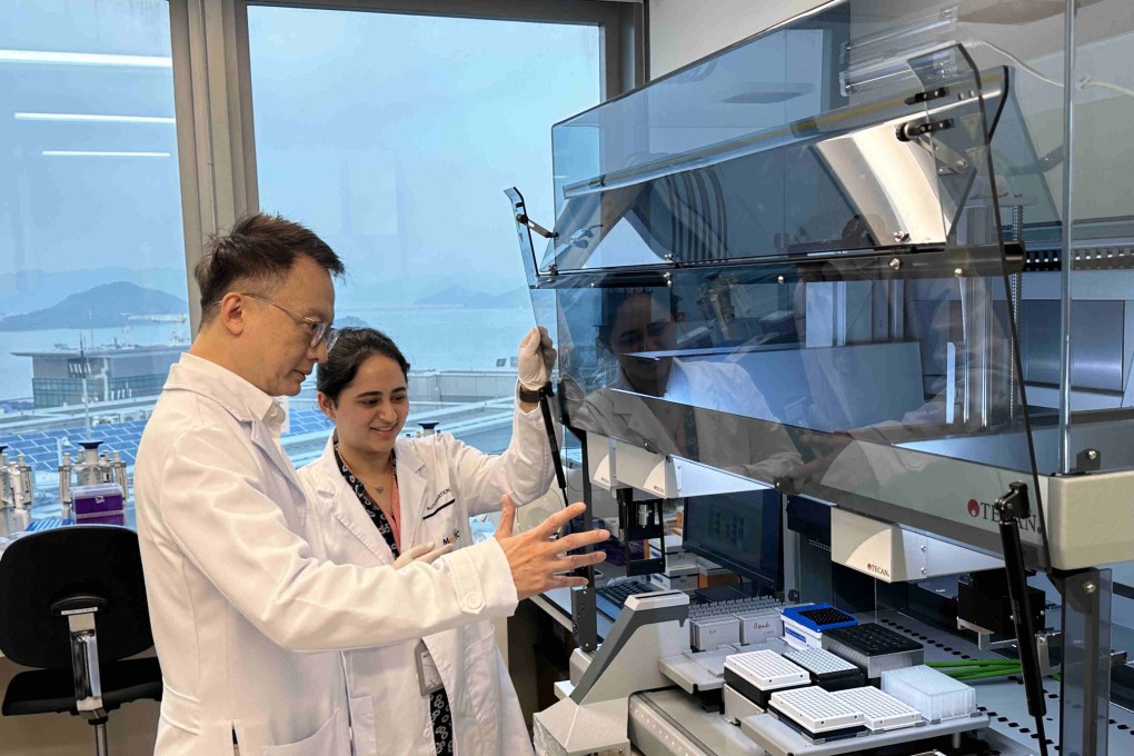 Professor Francis Chan (left) and the lab assistant demonstrate the new screening system. Photo: Fiona Chow