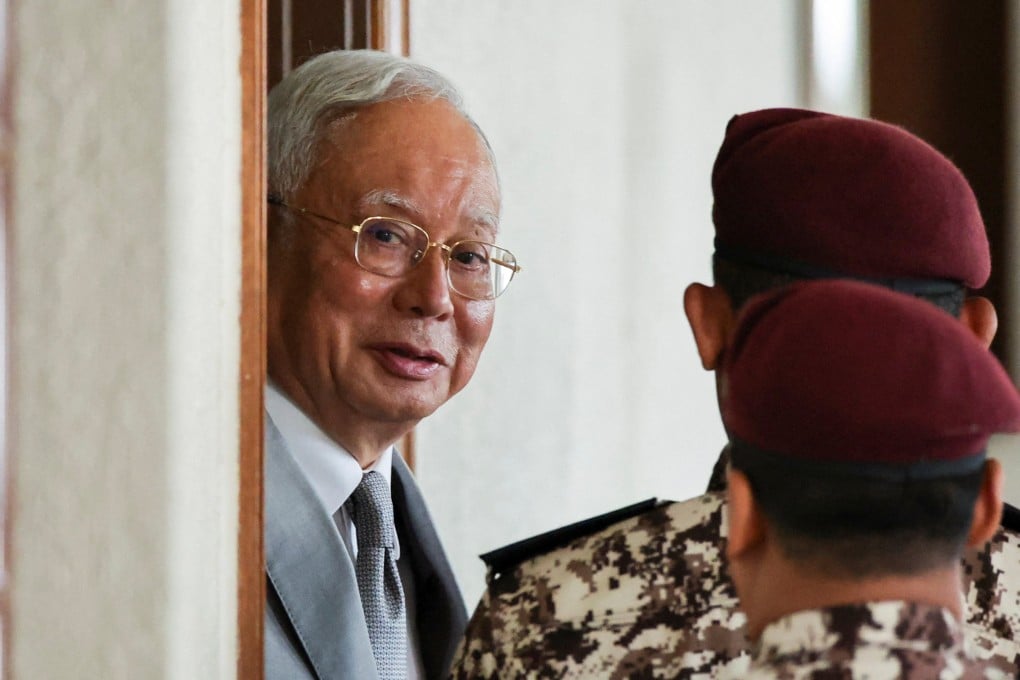 Malaysia’s former prime minister Najib Razak is escorted by prison guards at the Kuala Lumpur Court complex on Monday. Photo: Reuters