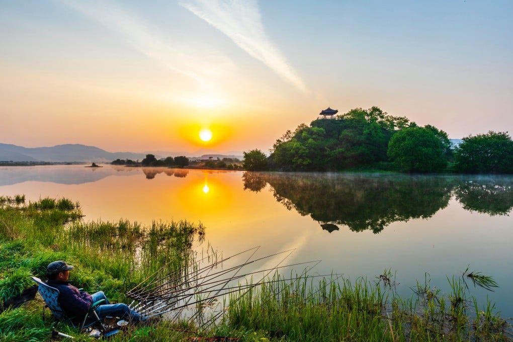 An angler fishing with the background of Sangchunjeong pavilion in Okcheon in North Chungcheong province, South Korea. Photo: Shutterstock
