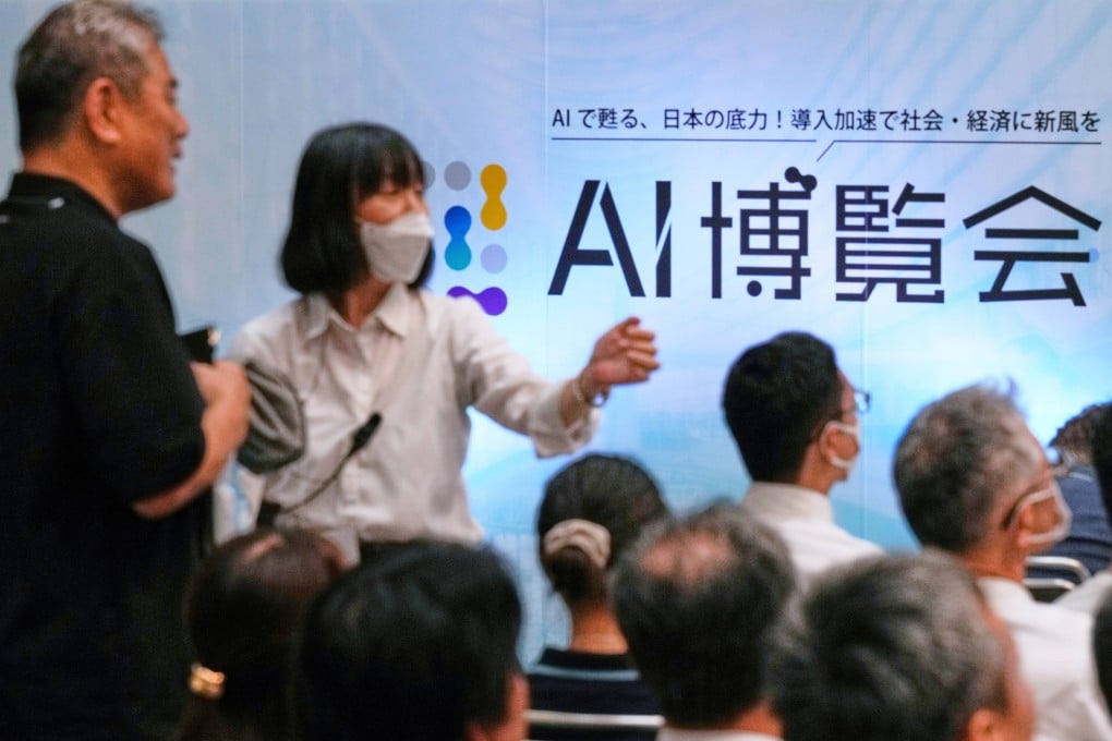 An usher directs an attendee to a seat for a seminar at an AI Expo convention, in Tokyo on August 27. Photo: AP