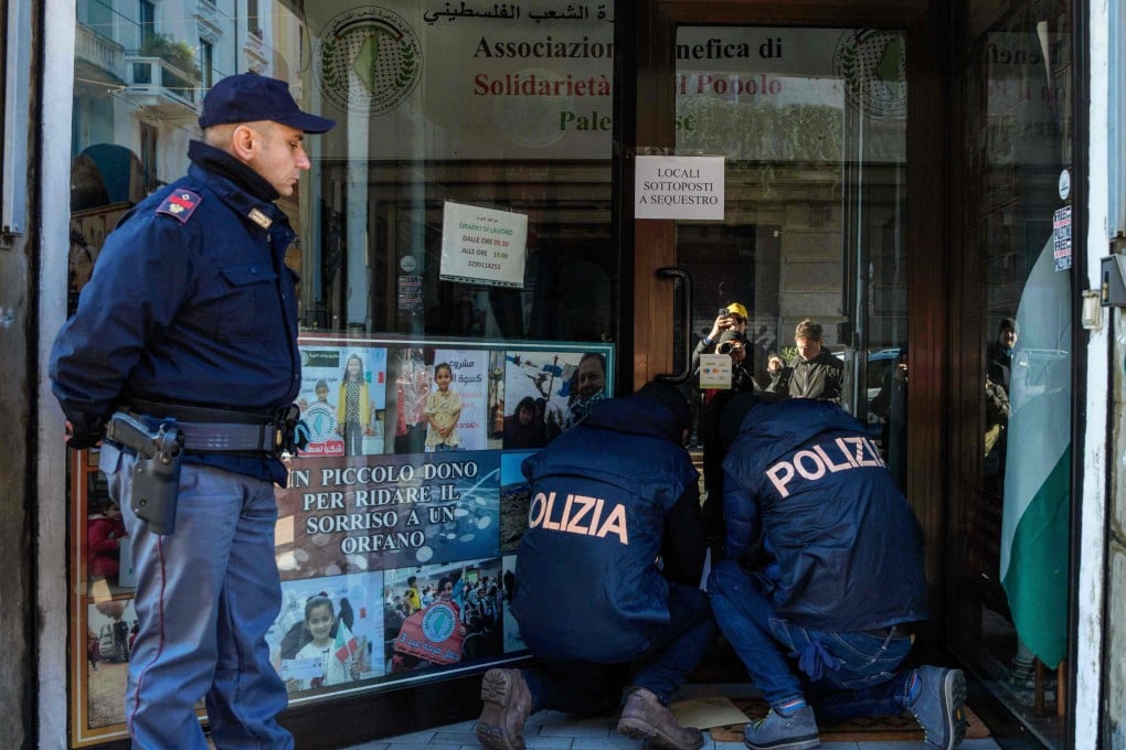 Police officers inspect a charity for Palestinian civilians in Milan on Saturday. Photo: LaPresse/AP