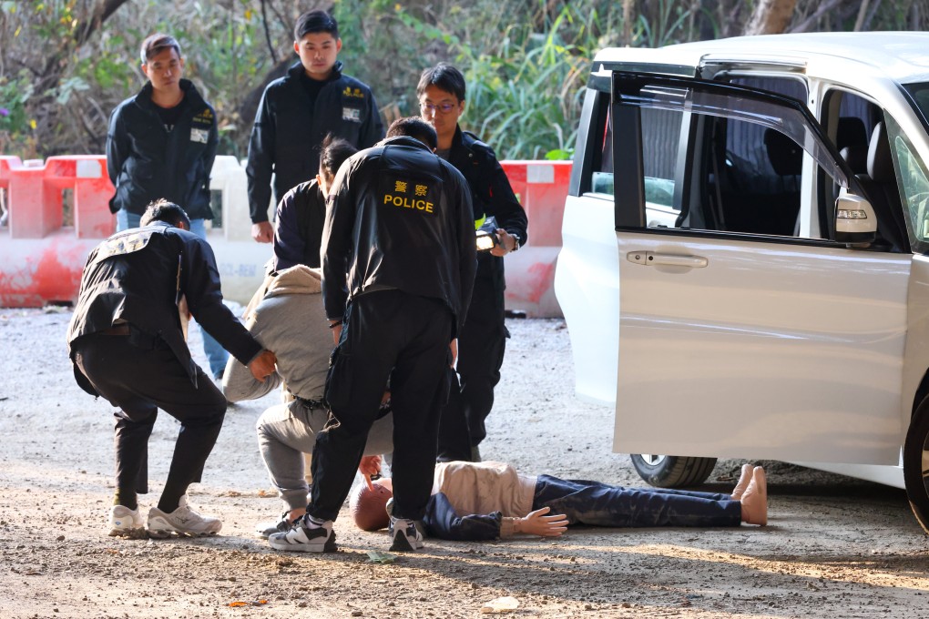 One of the two men arrested on Friday takes part in a reenactment on Yick Yuen Road. Photo: Dickson Lee
