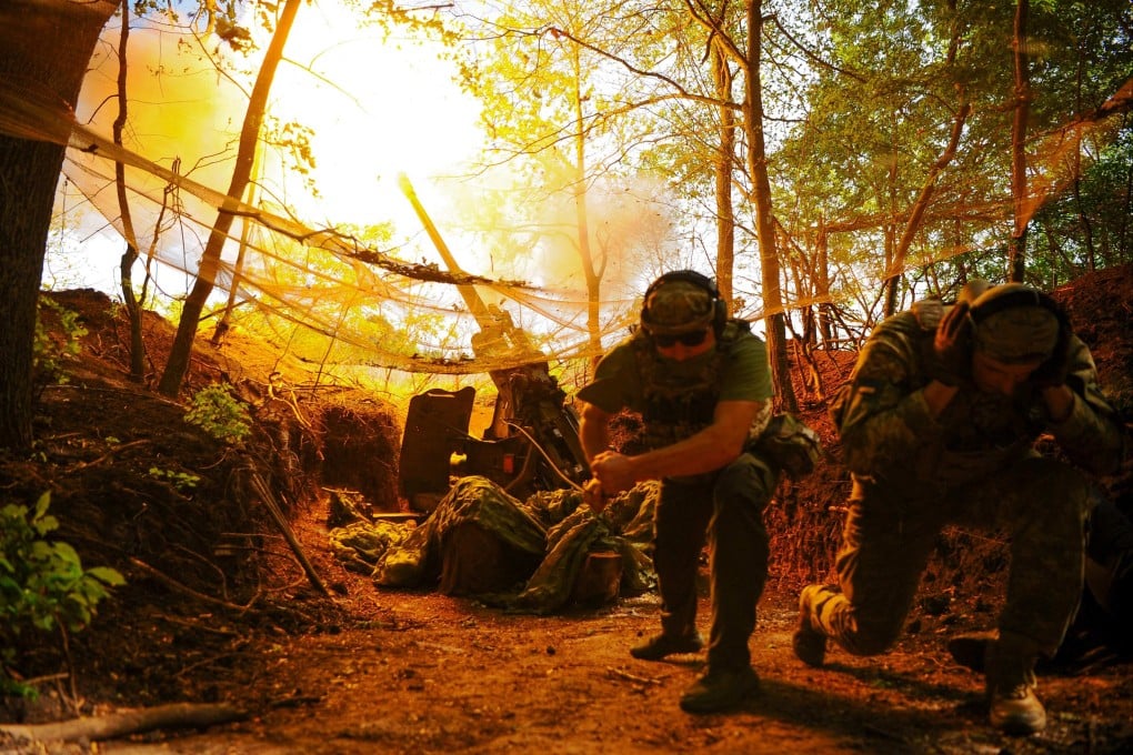 Members of the Ukrainian military take cover during an operation in June. Photo: AFP
