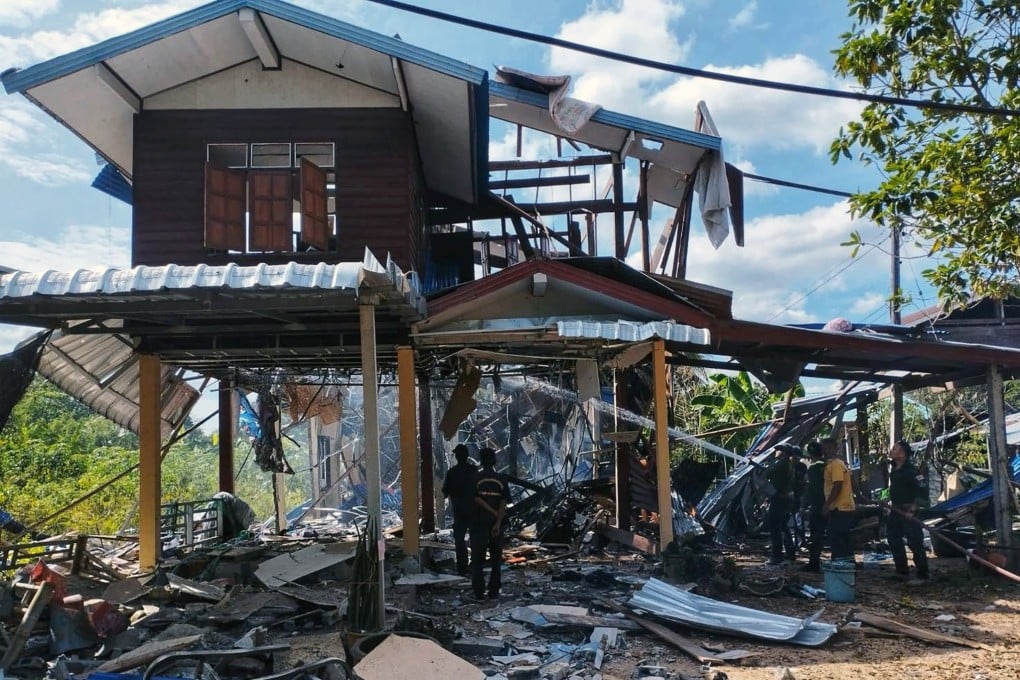 Rescue workers extinguishing a fire at a house after it was hit by Cambodian rocket strikes during clashes between Thai and Cambodian troops, at a village in Kantharalak district, Si Sa Ket province, Thailand, on December 14. Photo: EPA/Royal Thai Army