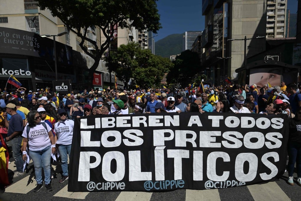 Demonstrators hold a banner demanding the release of all political prisoners during a protest in Caracas, Venezuela on January 9. On Friday, the prisons authority said it had released 99 prisoners. Photo: AFP
