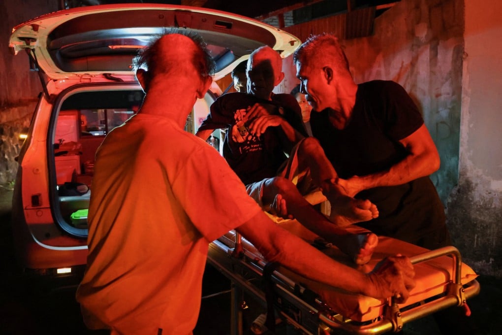 Local people rescue an elderly man from the retirement home fire. Photo: Reuters