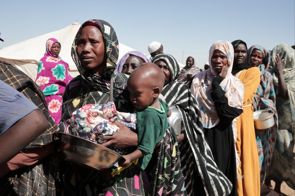 Women displaced by fighting in Sudan line up to receive food aid at a camp in Al Dabbah. Photo: AP
