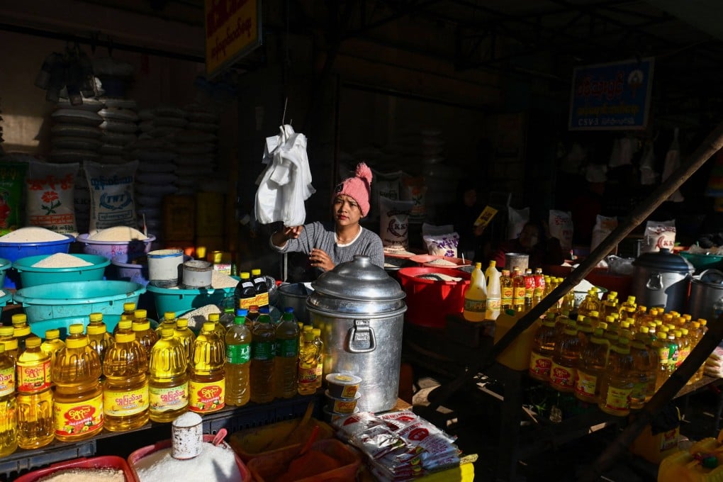 A vendor waits beside bottles of oil at a market in Pyin Oo Lwin, Myanmar. Inflation in the country has reached record highs of about 30 per cent over the past two years. Photo: AFP