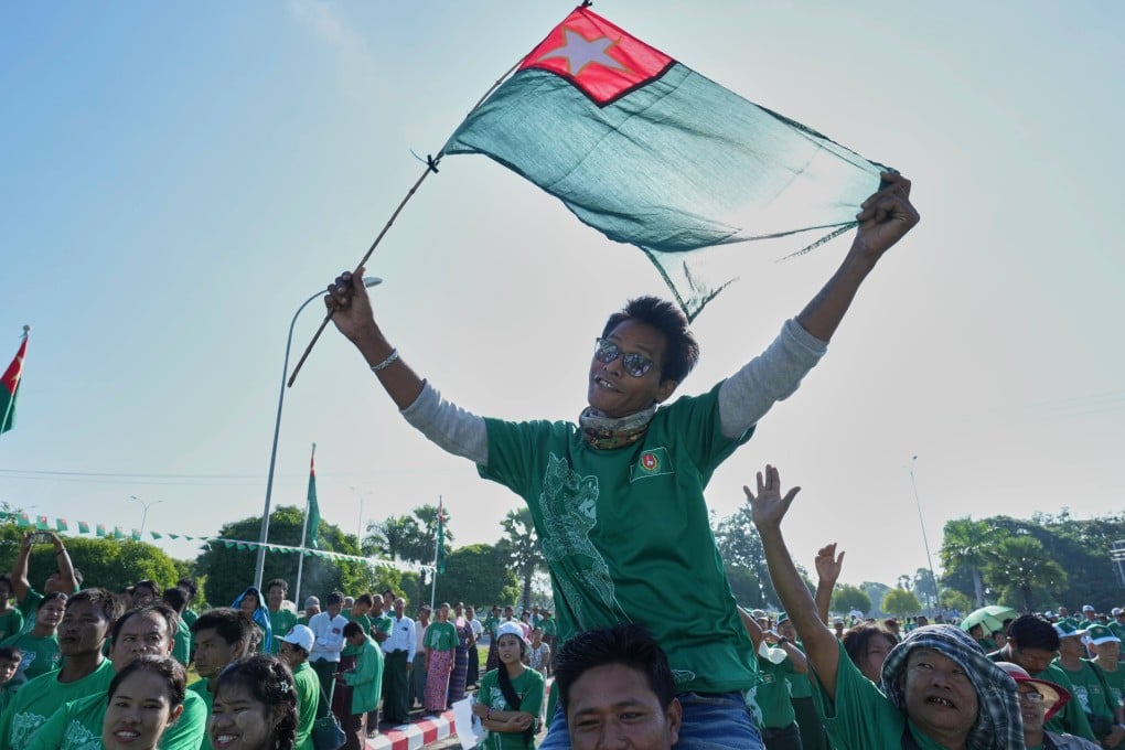 A USDP supporter waves a party flag on the first day of the general election campaign in Naypyidaw, Myanmar, on October 28. Photo: AP