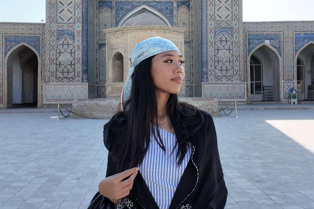 Kaylie Lau outside Kalan Mosque, in Bukhara, Uzbekistan. Earlier this year, the Post spoke to the Hongkonger who is currently on a trip from Asia to Europe, taking no flights and carrying only one backpack. Photo: Kaylie Lau