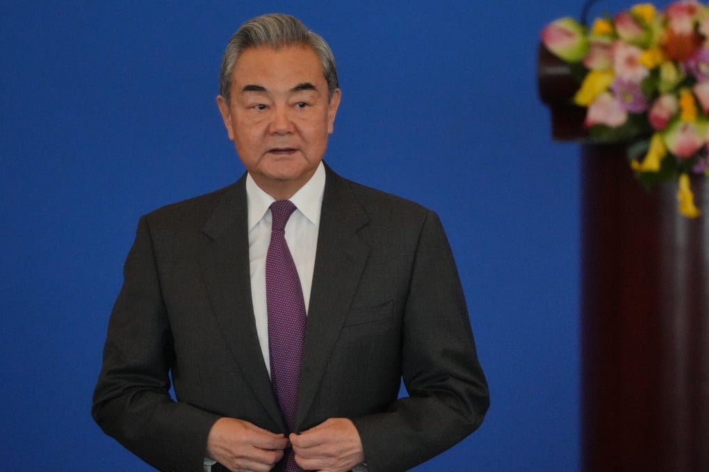 China’s Foreign Minister Wang Yi arrives to deliver an opening speech at the annual Symposium on the International Situation and China’s Foreign Relations in Beijing on Tuesday. Photo: AP