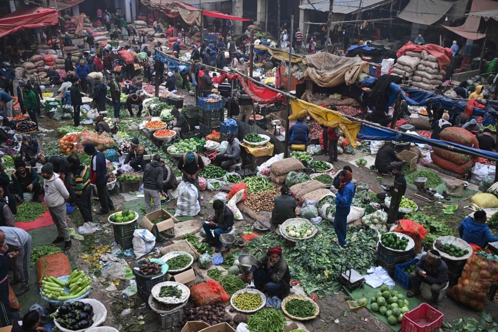 People buy vegetables at a market in the old quarters of New Delhi on Tuesday. Photo: AFP