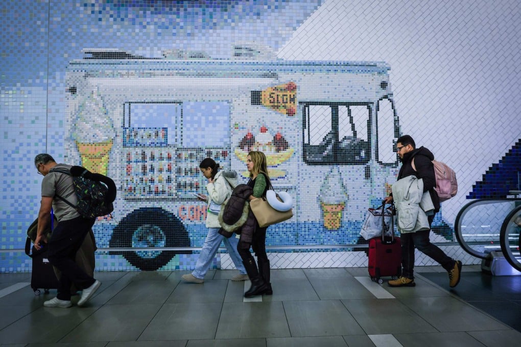 Travellers walk through the arrival hall at La Guardia Airport in New York on December 23, 2025. Photo: AFP