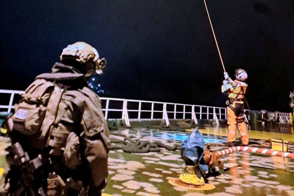 Two Finnish officials on the deck of an oil tanker in December 2024 that was suspected of sabotaging a power cable linking Finland and Estonia. Photo: Handout via AFP