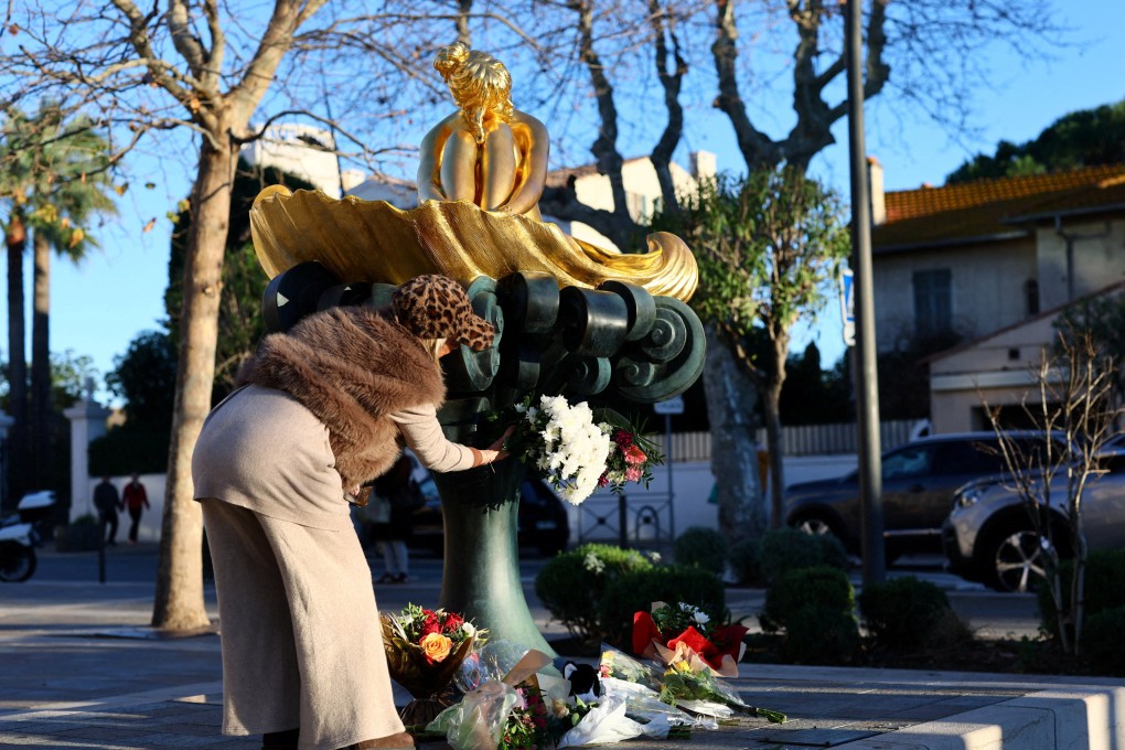 A woman places a floral tribute at the statue of the late French singer, actor and animal rights activist Brigitte Bardot, at Place Blanqui in Saint-Tropez, France. Photo: Reuters