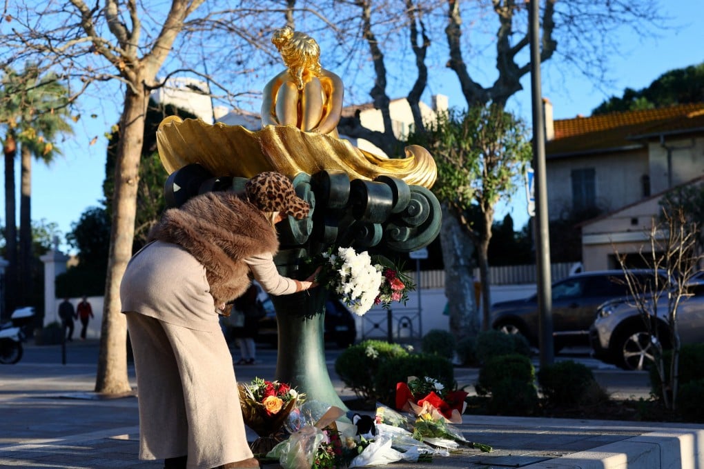 A woman places a floral tribute at the statue of the late French singer, actor and animal rights activist Brigitte Bardot, at Place Blanqui in Saint-Tropez, France. Photo: Reuters