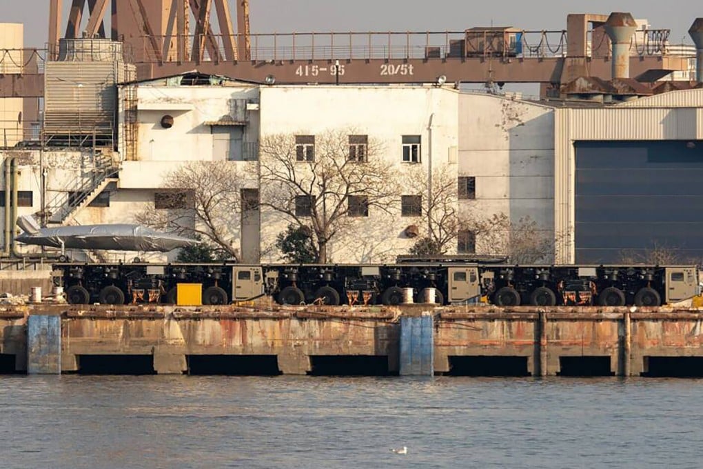 Three trucks linked to form what appears to be a launch track for large drones have been spotted at a dock in China. Photo: Handout