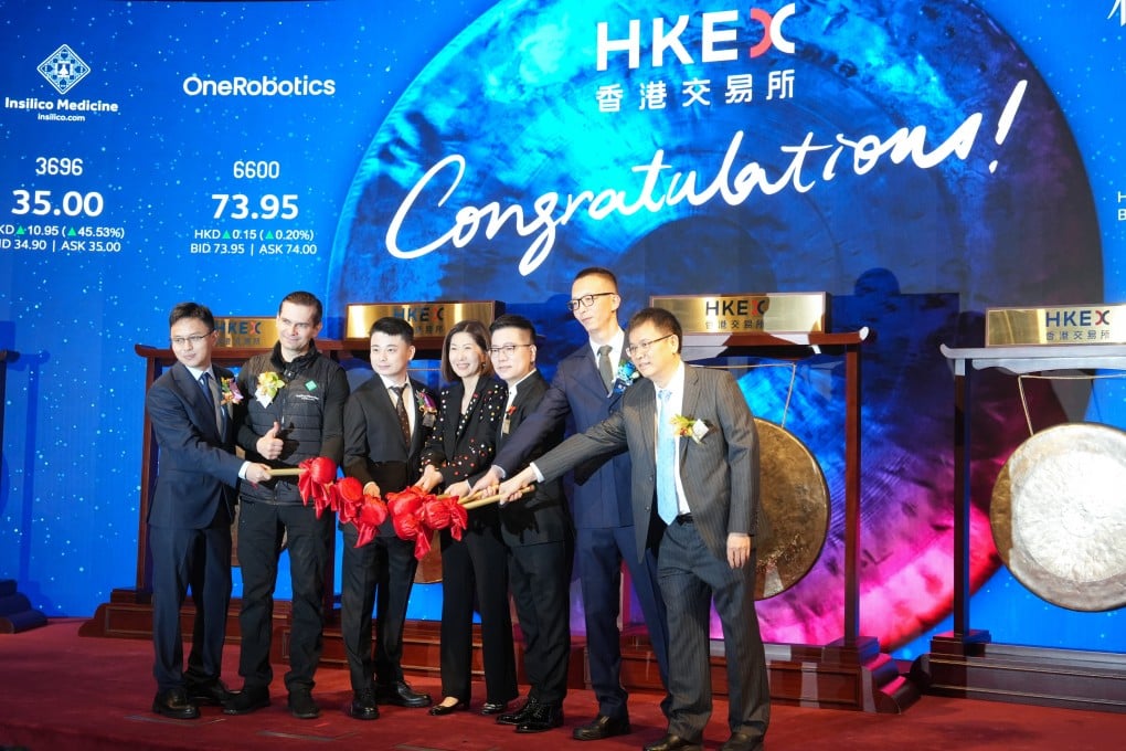Bonnie Chan Yiting (centre), CEO of Hong Kong Exchanges and Clearing, with (left to right) Li Yi, chairman of Beijing 51WORLD Digital Twin Technology; Alex Zhavoronkov, chairman and CEO of Insilico Medicine; Li Zhichen, chairman and CEO of OneRobotics (Shenzhen); Sun Laichun, chairman of Shanghai Forest Cabin Cosmetics Group; Geng Dawei, executive director and general manager of Shenzhen Xunce Technology; and Brian B.Y.Chen, chairman of USAS Building System (Shanghai). The six companies began trading on the Hong Kong exchange on December 30. Photo: Sun Yeung