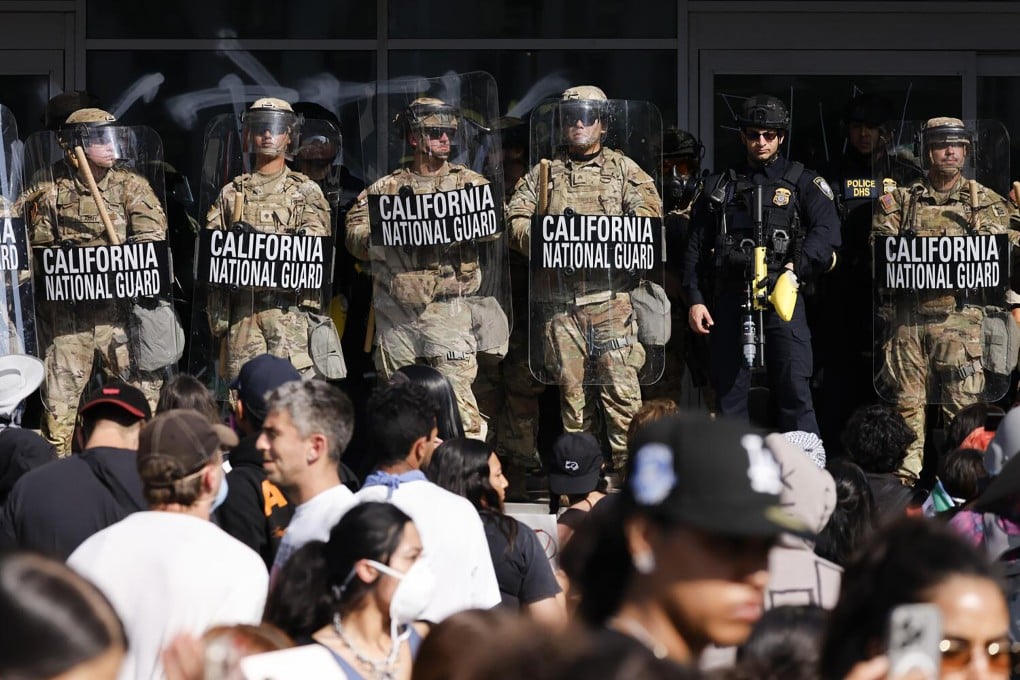 California National Guard members hold a line in front of anti-ICE protesters in Los Angeles in June. Photo: TNS
