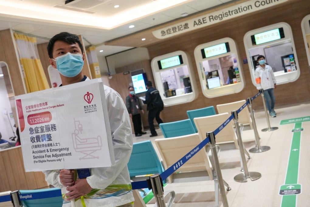 An employee at Kwong Wah Hospital holds up a sign publicising the fee revamp. Photo: Sun Yeung
