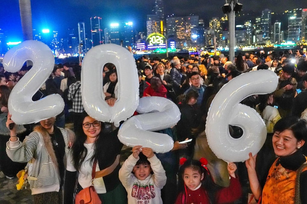 A family holds aloft festive balloons to mark the new year. Photo: Elson Li