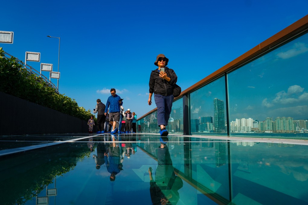 People walk on the glass floor of the eastern section of the East Coast Boardwalk in North Point on December 29. Photo: Sam Tsang
