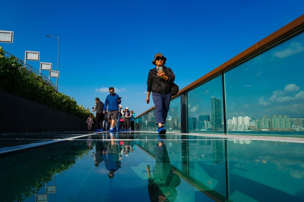People walk on the glass floor of the eastern section of the East Coast Boardwalk in North Point on December 29. Photo: Sam Tsang