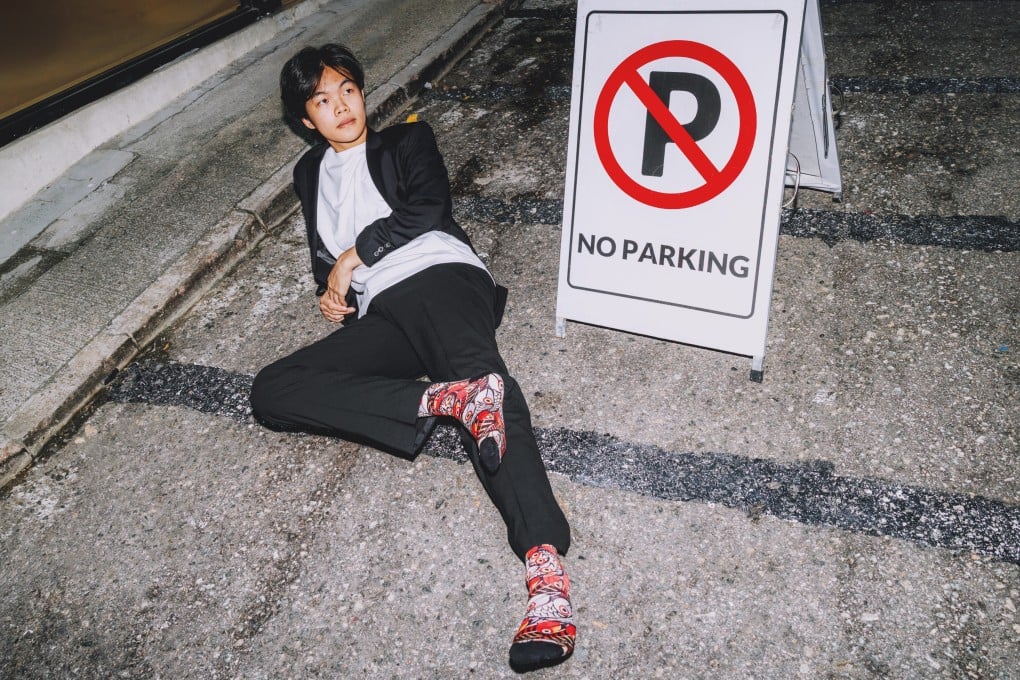 Founder of Sababu Socks, Darren Lee, sports a pair of Fishy on Me socks, designed by Tanzanian artist Chinga. Photo: Jocelyn Tam