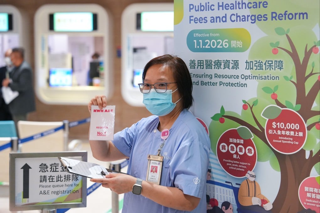 A hospital staff member holds a queue token at Kwong Wah Hospital’s A&E department on December 31, the day before the hospital fee revamp. Photo: Sun Yeung