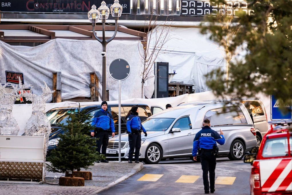 A hearse and police officers outside Le Constellation bar and lounge in Crans-Montana, Switzerland. Photo: Keystone via AP