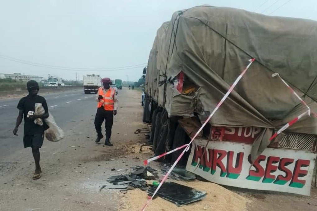 People walk past the scene of a crash involving British boxer Anthony Joshua in Lagos, Nigeria on Monday. Photo: Federal Road Safety Corps via AP