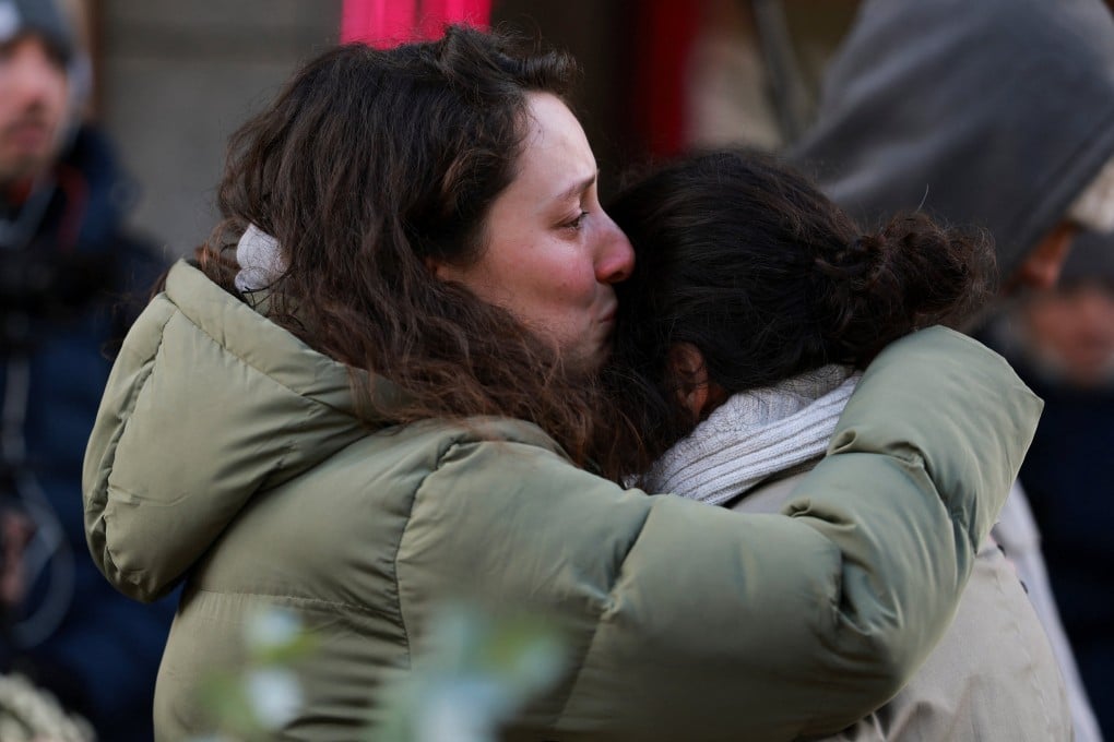 People comfort each other outside Le Constellation bar on Friday, a day, after a fire and explosion killed dozens of people in Crans-Montana, Switzerland. Photo: Reuters