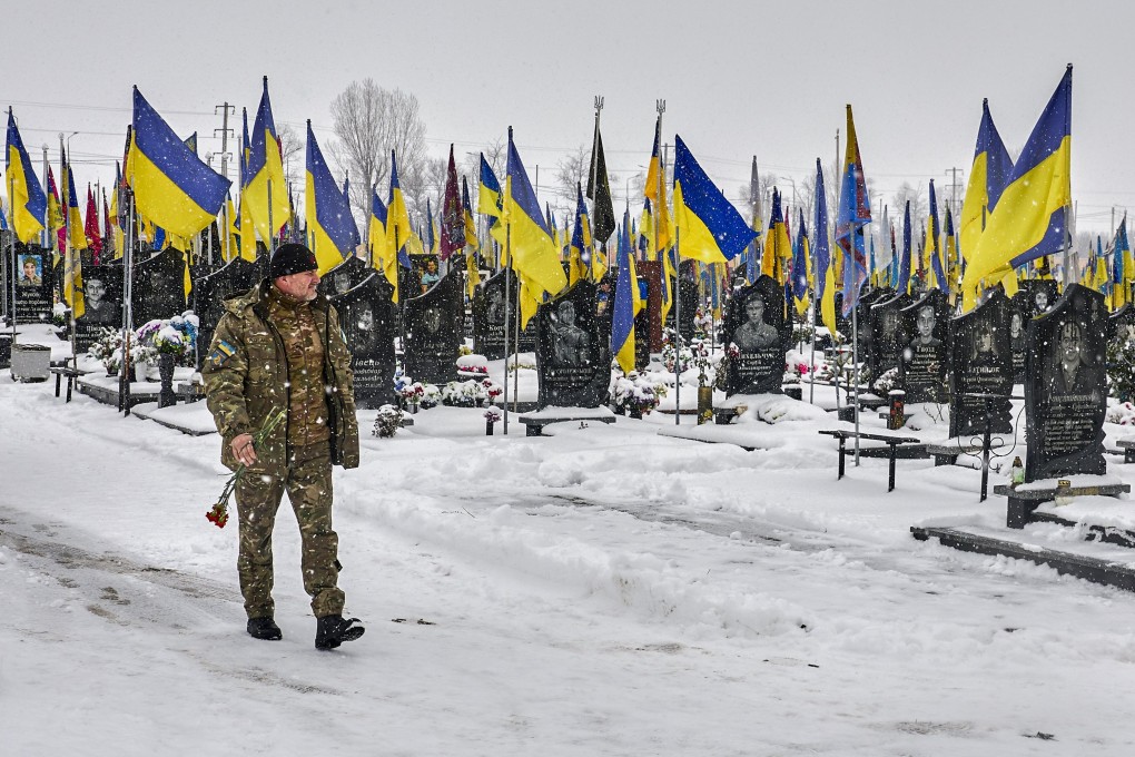 A Ukrainian soldier arrives to visit a grave on the Alley of Heroes at the military cemetery in Kharkiv, northeastern Ukraine, on Sunday. Photo: EPA