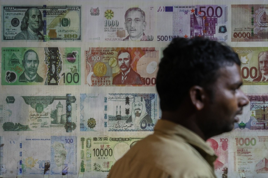 A man stands in a currency exchange shop in Mumbai. India has been stepping up efforts to diversify trade, signing deals with countries including New Zealand. Photo: EPA