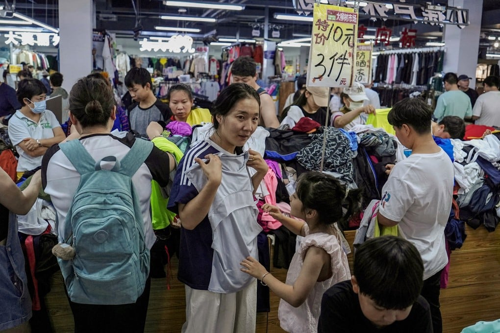 Customers shop at a discount clothing shop in Beijing. Photo: Reuters