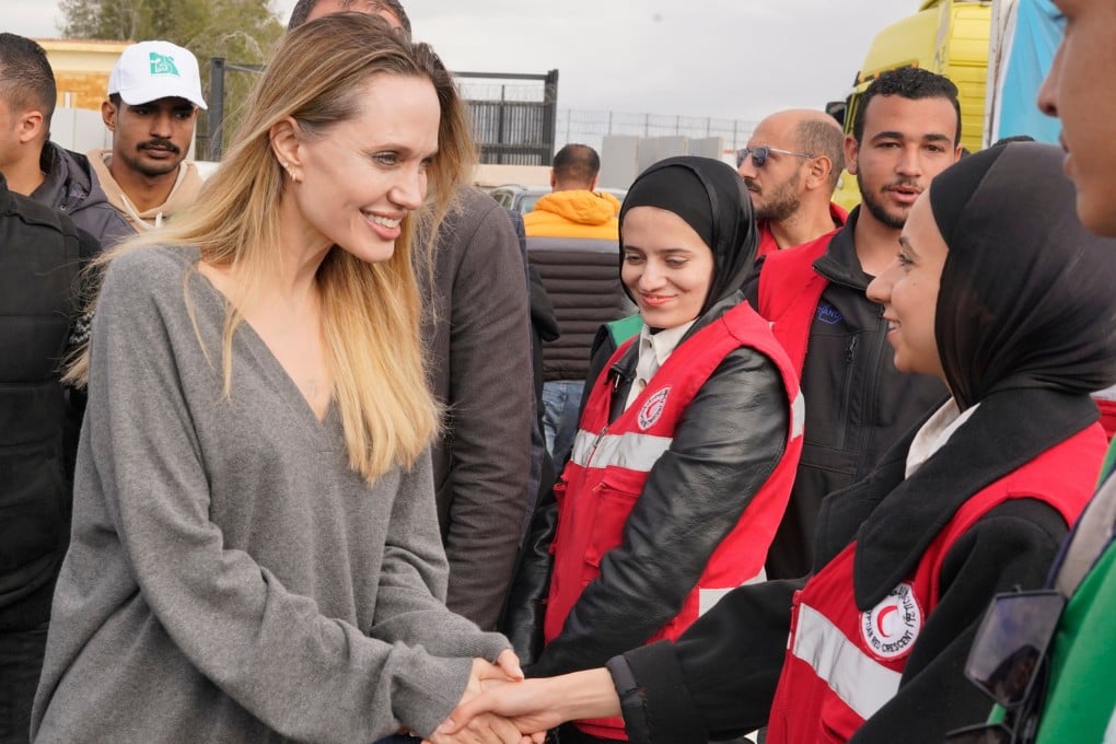 American actress and film producer Angelina Jolie greets Red Crecent workers during her visit to the Rafah border crossing between Egypt and Gaza on Friday. Photo: AP