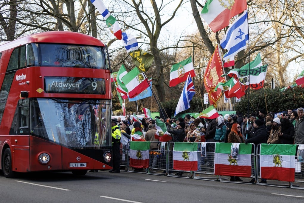 A bus drives past a protest by anti-government demonstrators and supporters of exiled Crown Prince of Iran, Reza Pahlavi, against the Iranian regime outside the embassy of Iran in London, Britain on Saturday. Photo: EPA