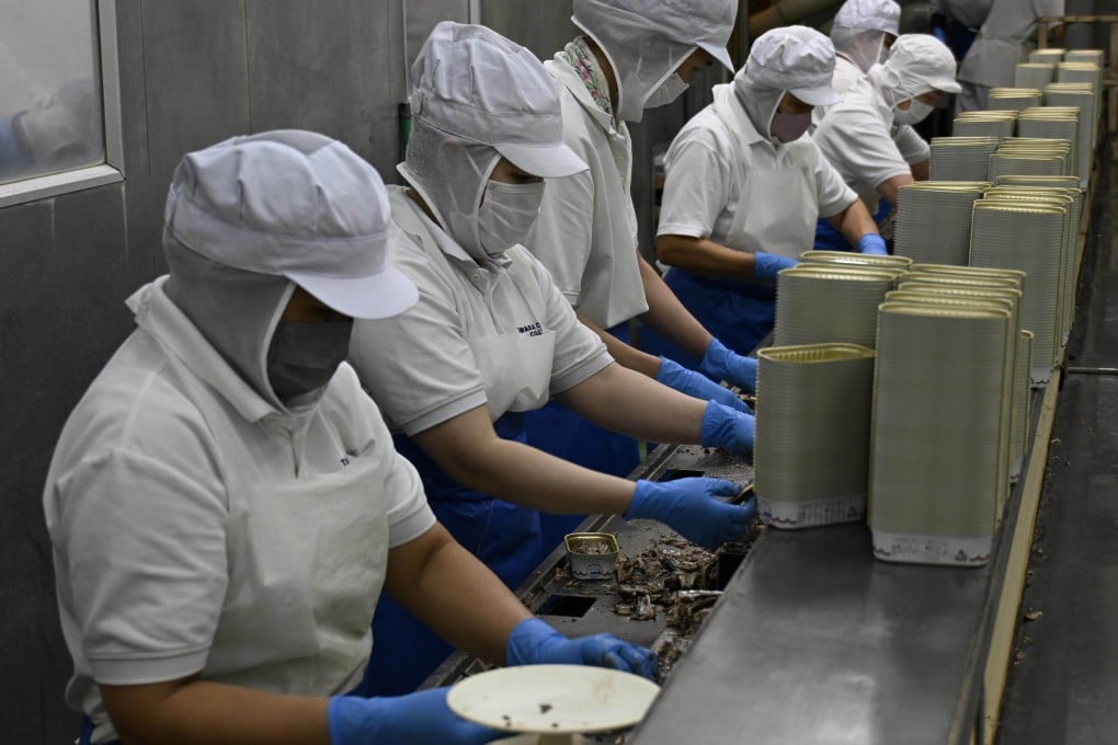 Vietnamese technical intern trainees work alongside Japanese employees at Tawara Canning in Choshi, Chiba prefecture. Photo: Kyodo