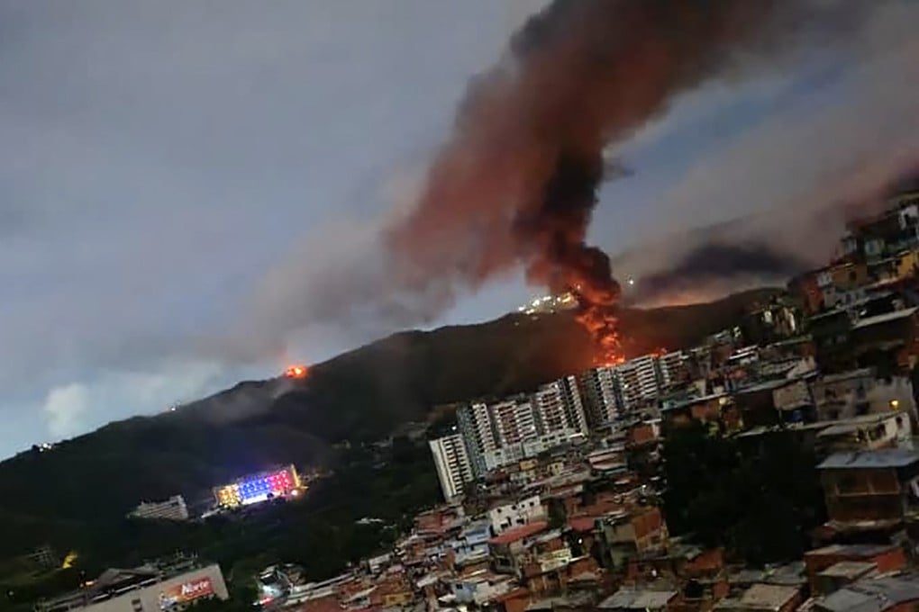 Fire rises from a Venezuelan military complex in Caracas on January 3, after US forces captured the country’s leader, Nicolas Maduro. Photo: AFP