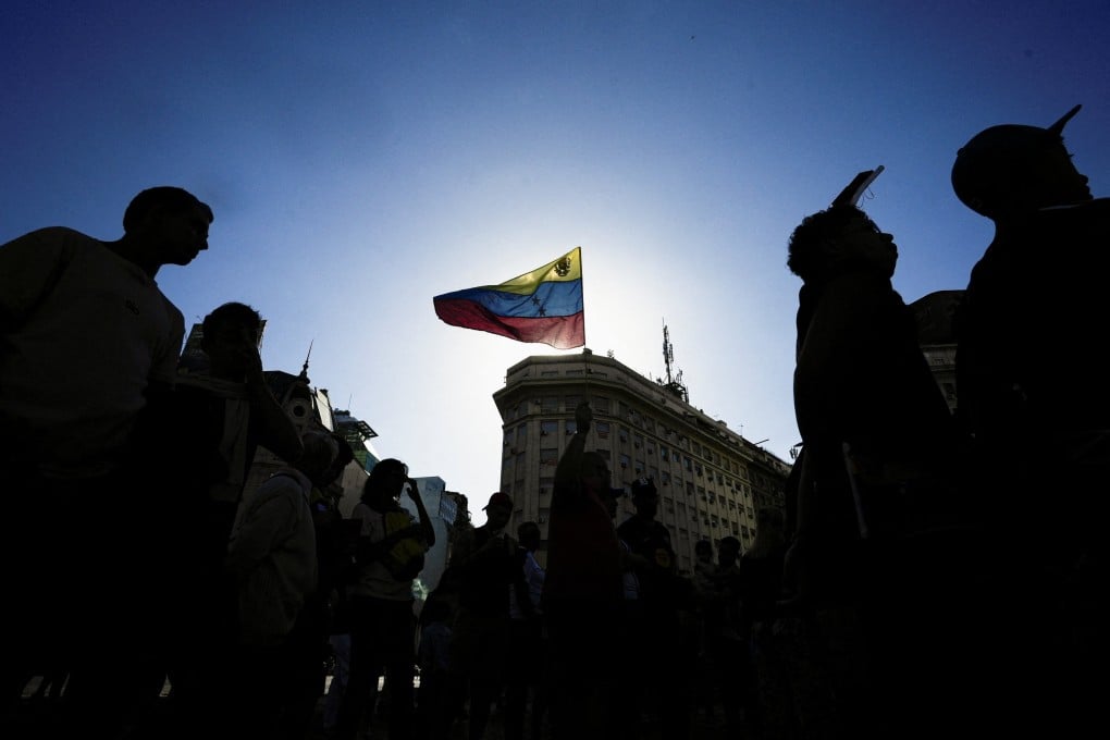 A Venezuelan flag is held up during a protest in Argentina calling for a democratic transition, after the US military strikes on fellow South American nation Venezuela. Photo: Reuters
