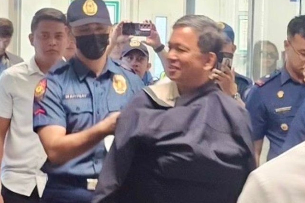 Romeo Poquiz (centre) is arrested on a sedition charge on Monday at Manila’s international airport. Photo: Philippine National Police

,