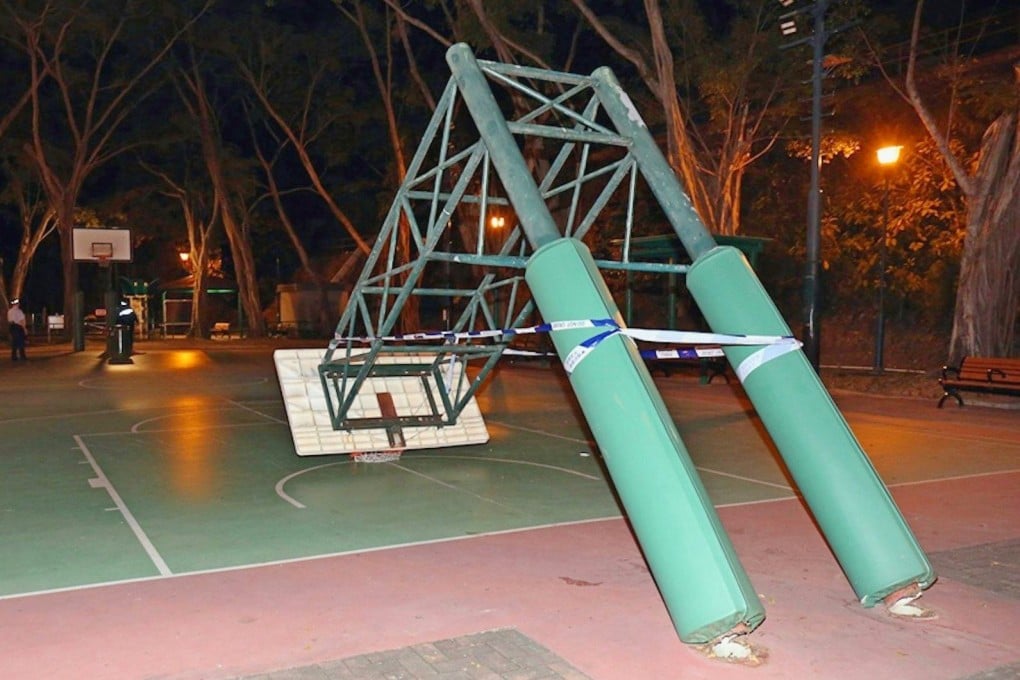 Online photos show the green basketball post tilted forward at a sharp angle, with the backboard and rim just above the ground. Photo: Facebook/Danny Law