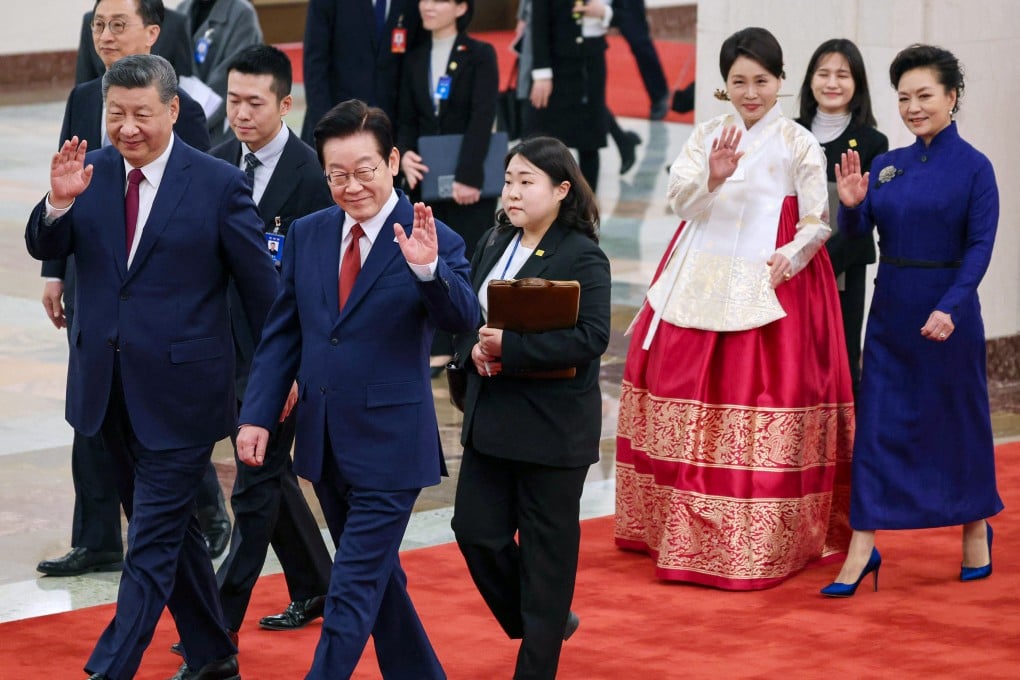 South Korean President Lee Jae Myung walks alongside Chinese President Xi Jinping as their spouses follow behind, during a welcoming ceremony in Beijing on Monday. Photo: AFP