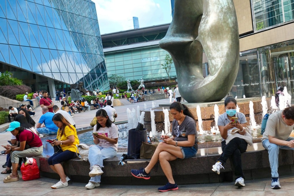 Domestic helpers gather in Hong Kong’s Central to relax and socialise on their Sunday day off. Photo: Karma Lo